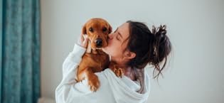 girl hugging dog